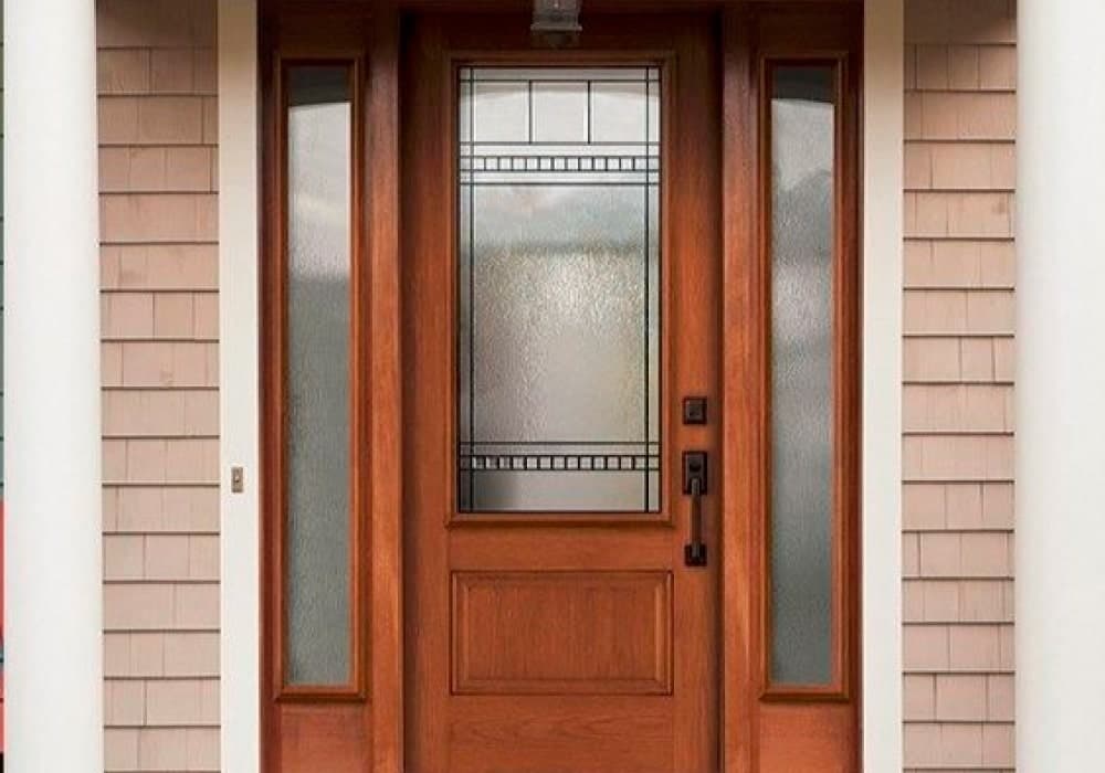 A wooden front door with decorative glass panels.