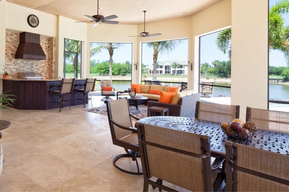 Spacious outdoor living area with comfortable seating and a view of the water