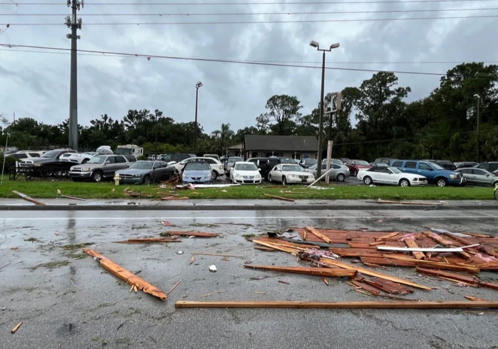 A parking lot with scattered debris after a storm.