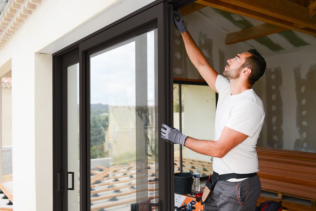 a man holding a glass door