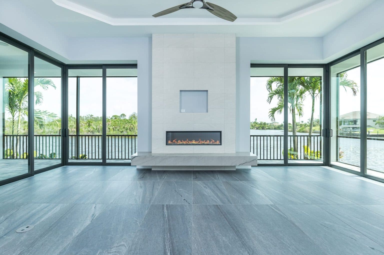 a room with a fireplace and a ceiling fan