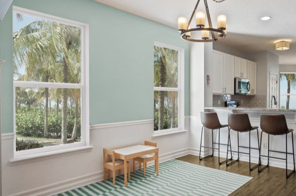 Bright dining and kitchen area featuring large windows.