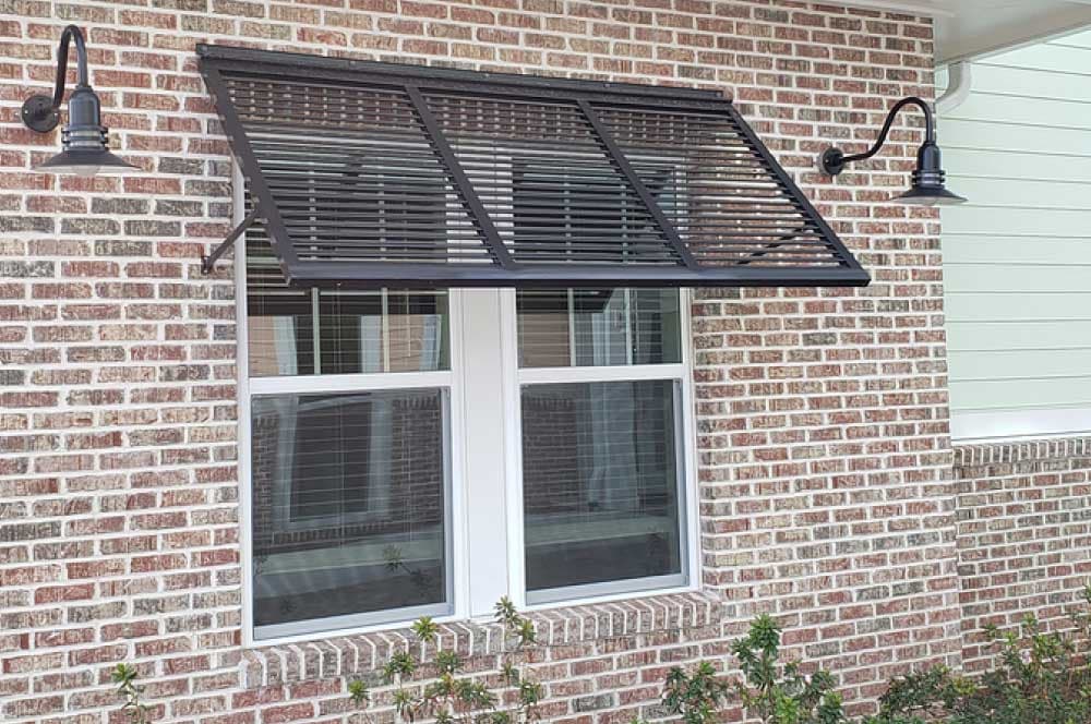 Bahama-style hurricane shutters in black above a double-pane window.