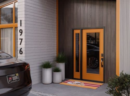 a house with a tangerine fiberglass door and plants with a car parked outside