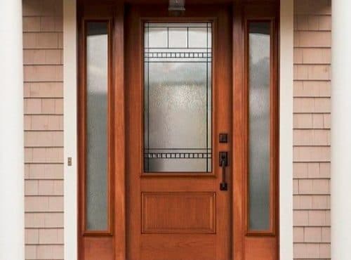 A wooden front door with decorative glass panels.